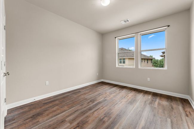 Spare room featuring dark wood finished floors and baseboards | Image 19