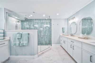 Bathroom with a shower with shower door, dual bowl vanity, and tile flooring | Image 3