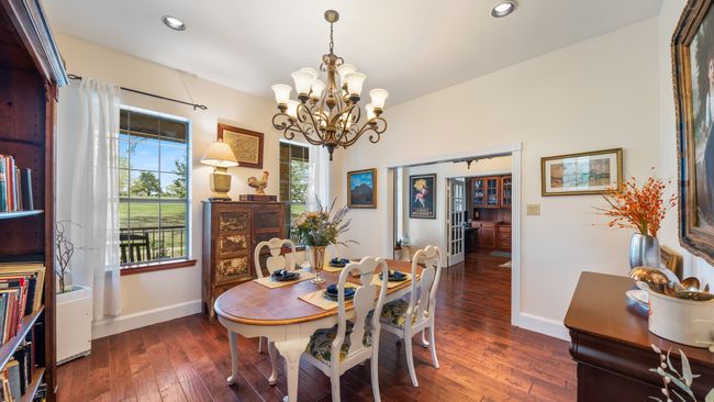 Dining space with hardwood / wood-style floors, baseboards, recessed lighting, and a notable chandelier | Image 11