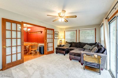 Living room featuring a textured ceiling, ceiling fan, french doors, and carpet floors | Image 3