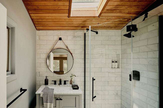 Full bath with wood ceiling, a stall shower, a skylight, and vanity | Image 17