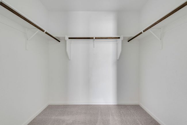 Walk in closet with carpet floors | Image 24