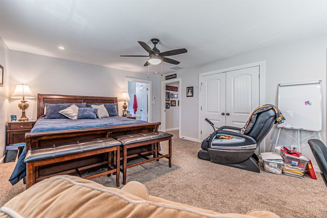 Carpeted bedroom with a closet, ceiling fan, and recessed lighting | Image 20
