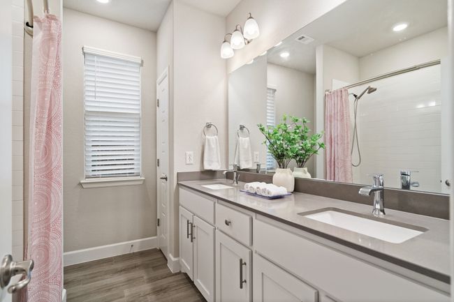 Bathroom with wood finished floors, double vanity, and curtained shower | Image 14