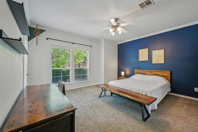 Carpeted bedroom with crown molding, baseboards, and ceiling fan | Image 15
