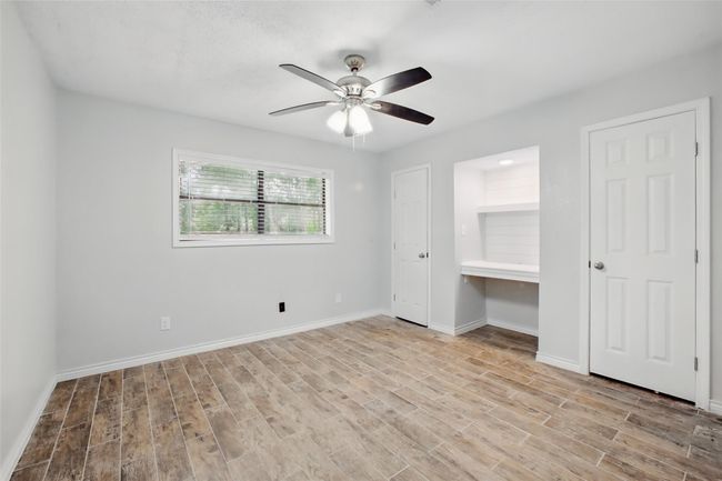 This secondary bedroom offer a balance of function and comfort, with a custom desk nook that's perfect for studying or as a vanity area. | Image 29