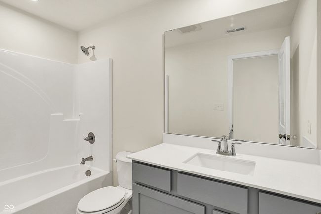 full bath with bathing tub / shower combination, visible vents, toilet, and vanity | Image 29