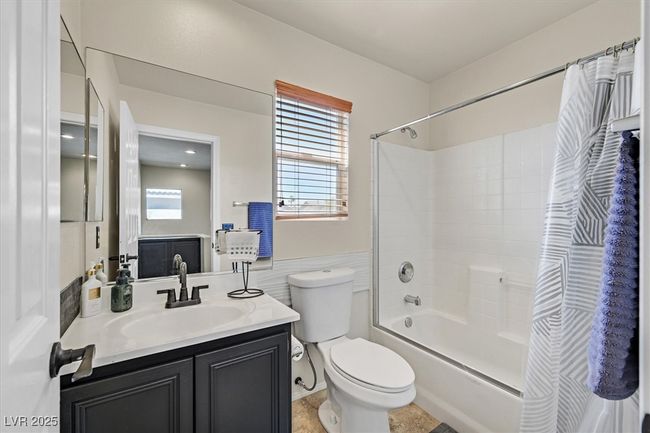 Full bath featuring toilet, vanity, and shower / bath combination with curtain | Image 26