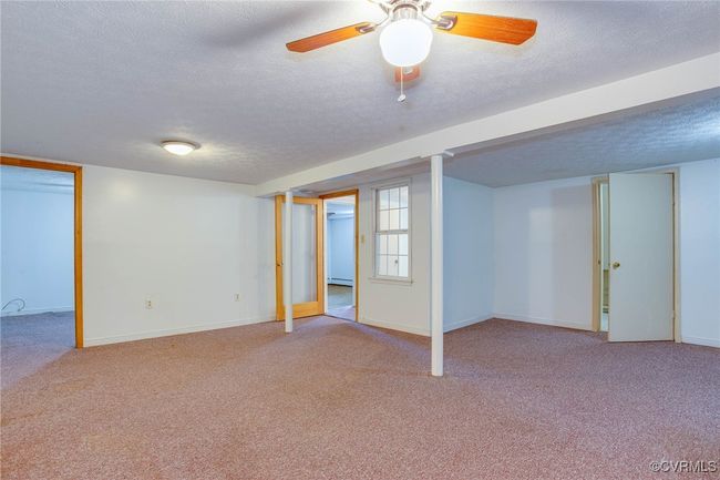 2nd unit Basement with a textured ceiling, carpet, and ceiling fan | Image 31