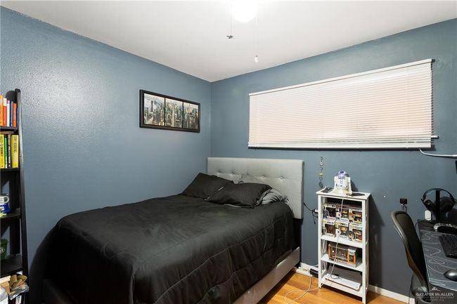 Bedroom with wood finished floors and baseboards | Image 9