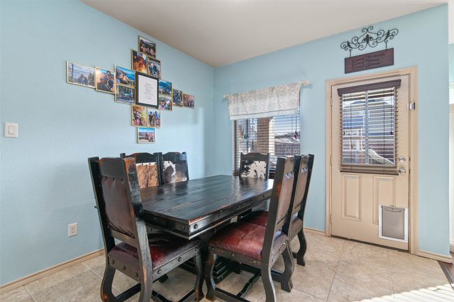 Dining area with light tile patterned flooring and baseboards | Image 17