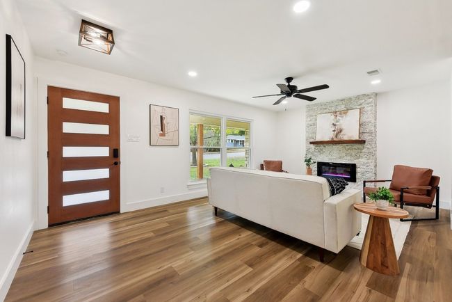 Living area featuring recessed lighting, a fireplace, baseboards, and wood finished floors | Image 9