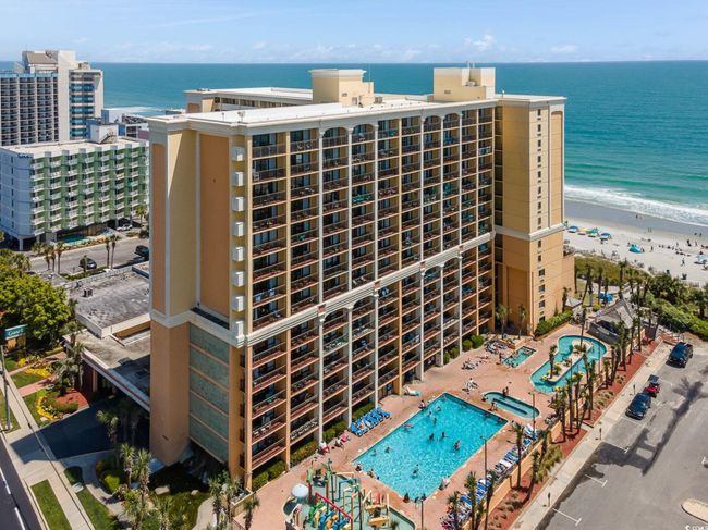 View of apartment building / complex with view of water and beach | Image 20