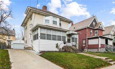 Front of property featuring a garage, an outdoor structure, and a front yard | Image 2