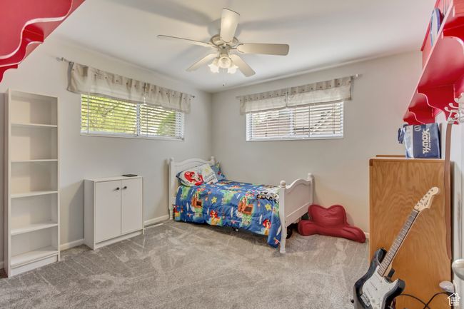Bedroom featuring ceiling fan, baseboards, and carpet flooring | Image 12