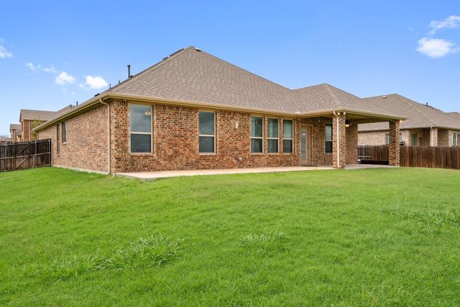 Back of property featuring a fenced backyard, brick siding, and a patio area | Image 31