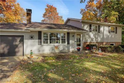 Split level home with a front lawn and a garage | Image 2