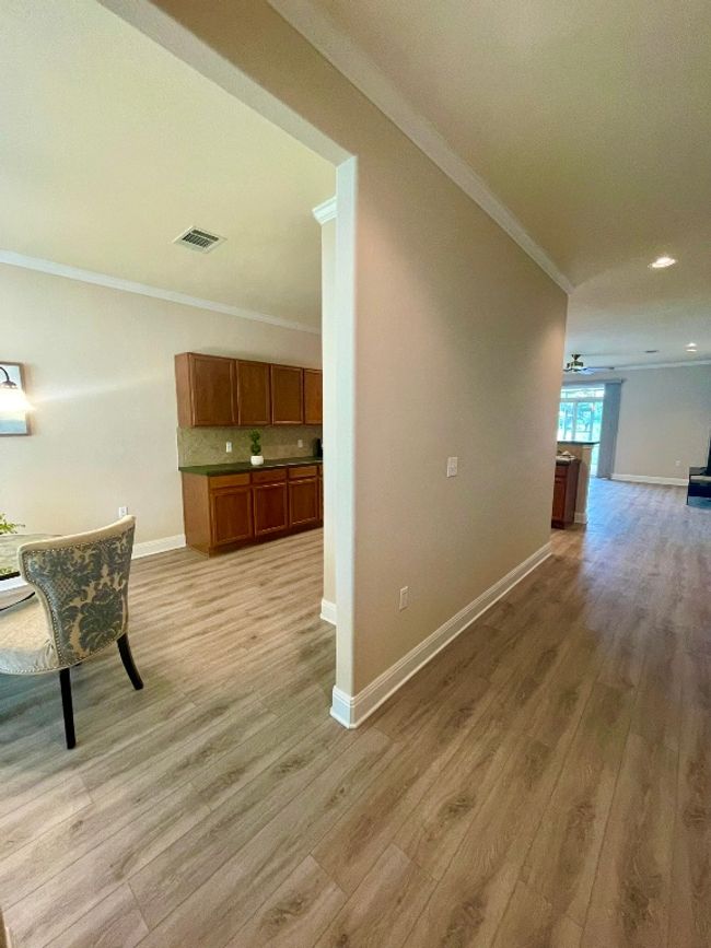 Hallway with crown molding, light wood-type flooring, and recessed lighting | Image 4