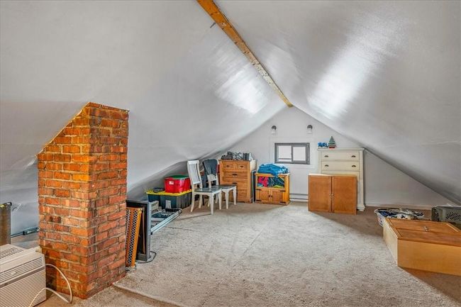 Game room featuring brick wall, baseboard heating, vaulted ceiling, and carpet | Image 31