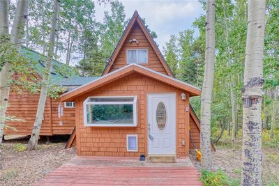 Welcome home! A beautiful courtyard connecting multiple points on the property greets you, surrounded by beautiful, mature aspen trees. | Image 1