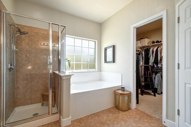 The deep soaking tub and separate walk-in shower provide the perfect place to relax after a long day. | Image 19