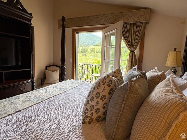 Bedroom with access to exterior and lofted ceiling | Image 14