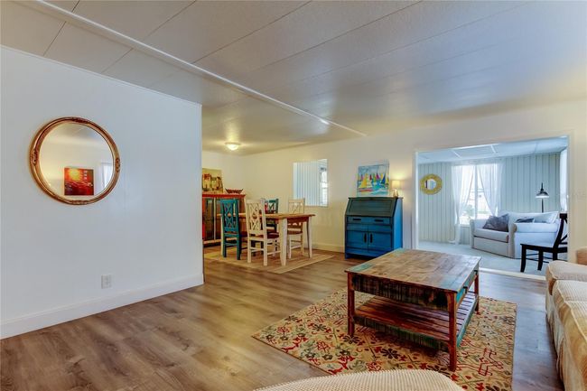 28.. Living & Dining Area is a HUGE GREAT ROOM tht Flows Into Kitchen & BONUS Room! LOVE the Cohesive & Tasteful Furnishings = ALL INCLUDED!! | Image 27