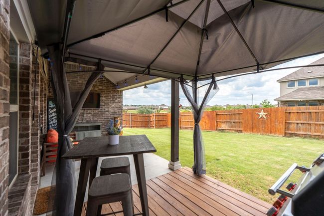 Wooden terrace featuring a fireplace | Image 27