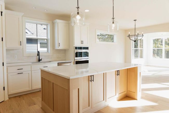 Large Custom Kitchen Island perfect for entertaining & gathering around! Includes storage on both sides! Photos may not depict actual home plan. Features/materials/finishes shown contain options that are not included in price. | Image 7