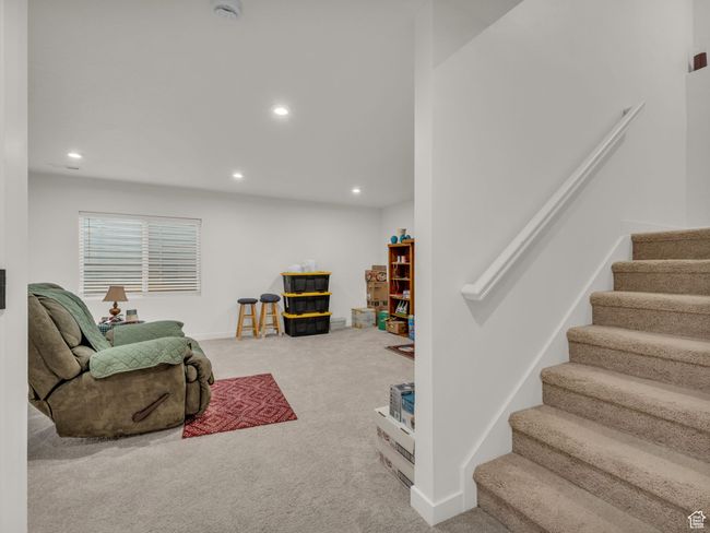 Carpeted living room with stairway, recessed lighting, and baseboards | Image 22