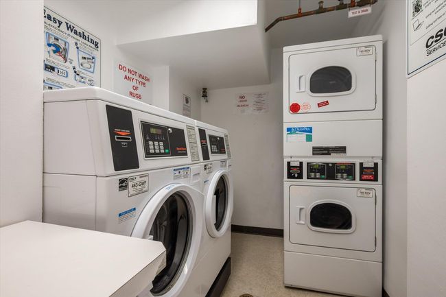 Communal laundry room with stacked washer / drying machine, washing machine and dryer, and baseboards | Image 20