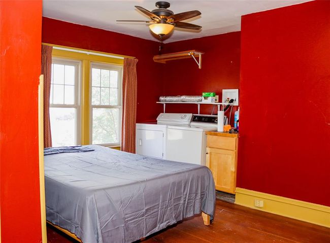 The north Bedroom featuring dark wood-style floors, and Laundry | Image 33