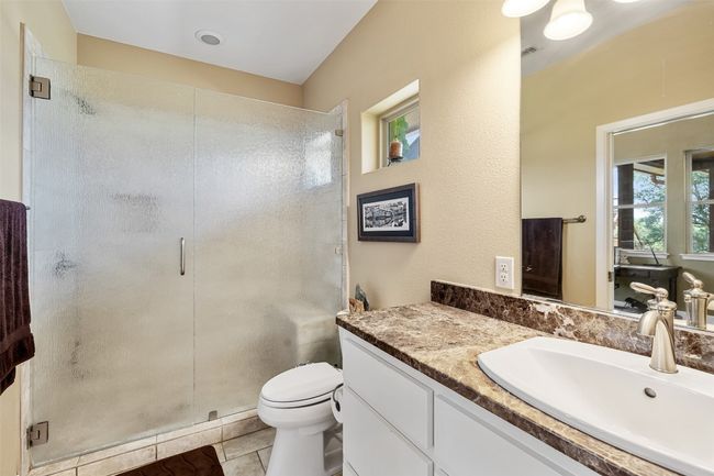Bathroom featuring vanity, a stall shower, and toilet | Image 33