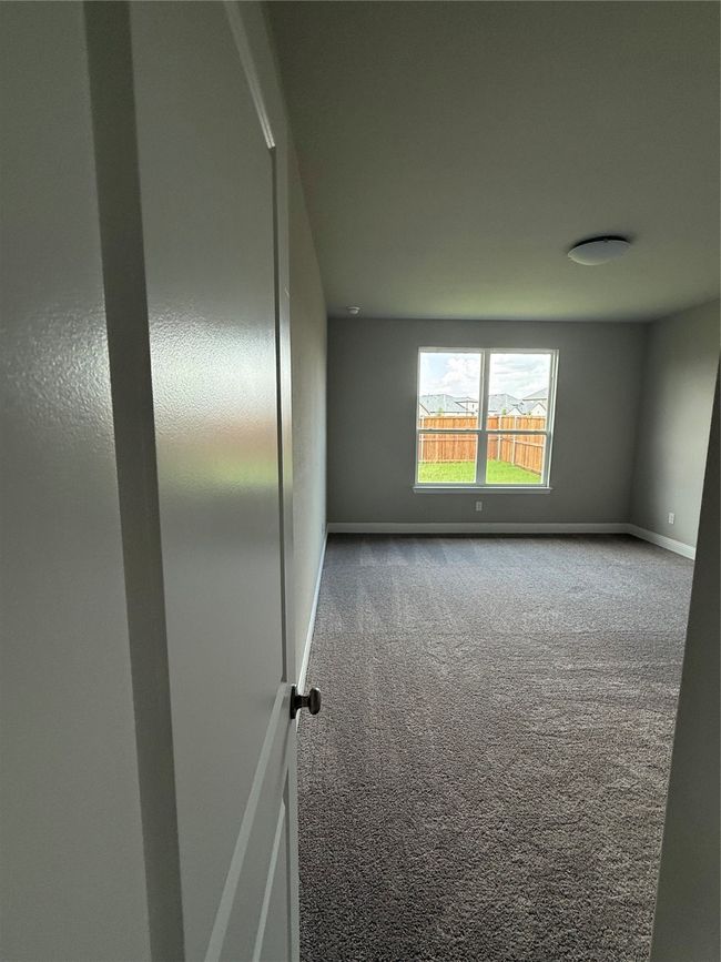Spare room featuring carpet floors and baseboards | Image 11
