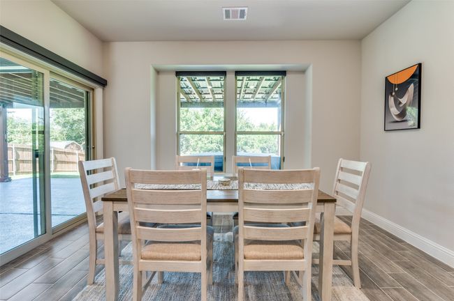 Dining area with wood finish floors and baseboards | Image 10