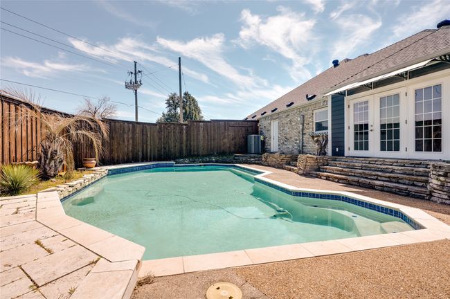 View of pool with a fenced in pool, a fenced backyard, french doors, a patio area, and central AC | Image 27