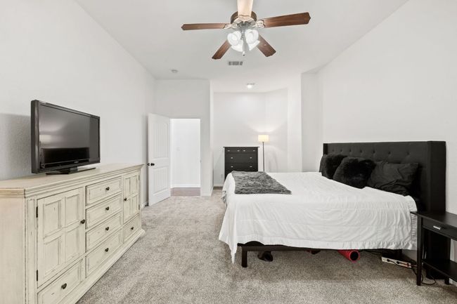 Bedroom featuring light carpet and ceiling fan | Image 24