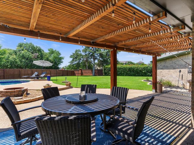 Fenced backyard with a patio, a pergola, and outdoor dining area | Image 30