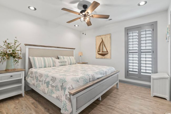 Bedroom with recessed lighting, wood finished floors, visible vents, a ceiling fan, and baseboards | Image 21