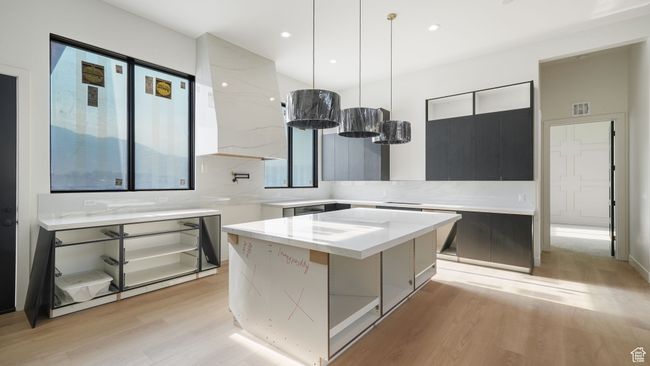 Progress pictures, 7/11/25: Kitchen featuring modern cabinets, light wood-style flooring, a center island, hanging light fixtures, and recessed lighting | Image 9