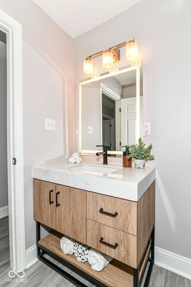 bathroom with vanity, baseboards, and wood finished floors | Image 23