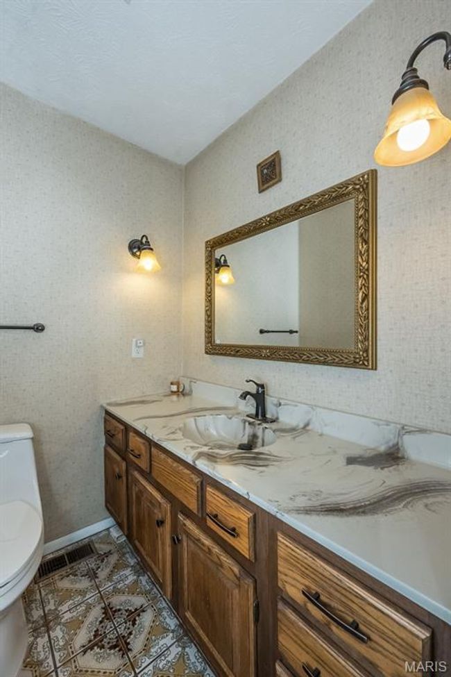Half bath with vanity, toilet, and wallpapered walls | Image 11