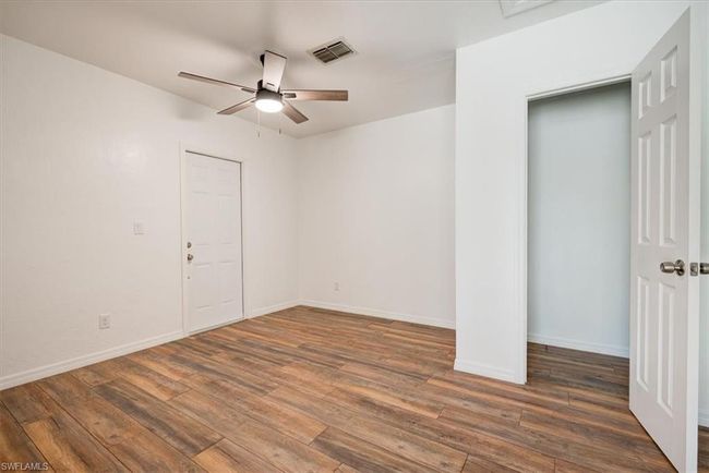 Empty room featuring wood finished floors, visible vents, a ceiling fan, and baseboards | Image 35