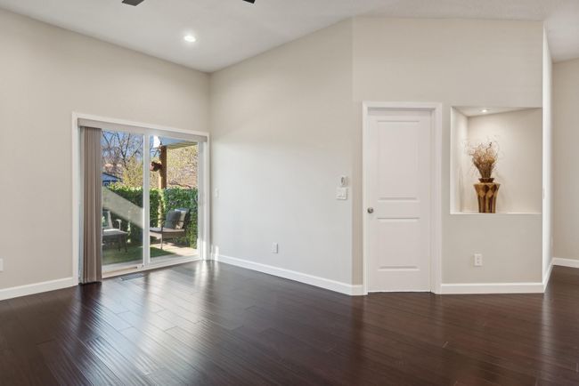 The living room features extremely high ceilings, beautiful flooring, loads of natural light and fresh paint. The height and design of this space feels both quaint and sleek. | Image 15
