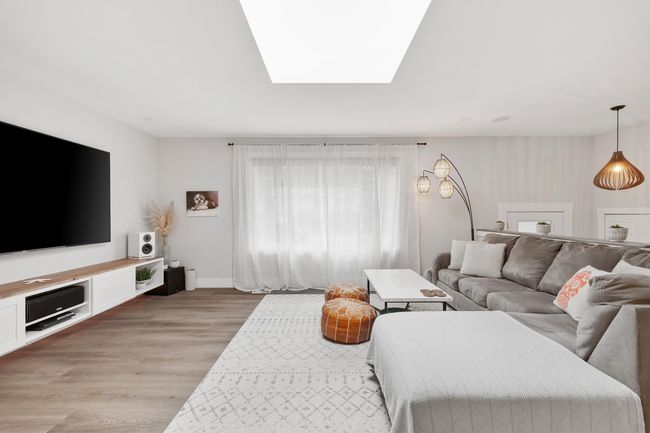 Living room featuring light wood-type flooring and baseboards | Image 17