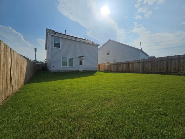 Rear view of property with a yard and a fenced backyard | Image 34