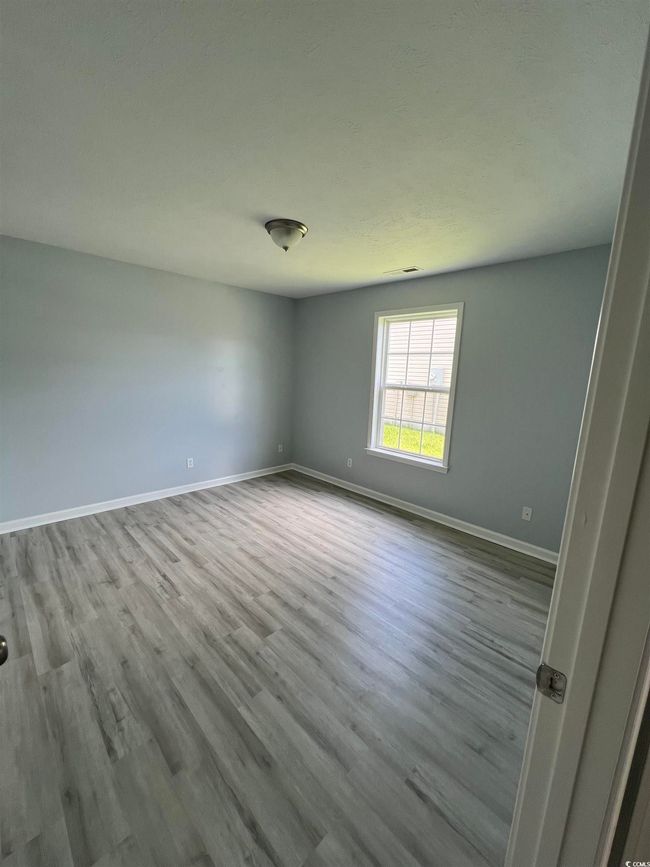 Unfurnished room with wood finished floors and baseboards | Image 10