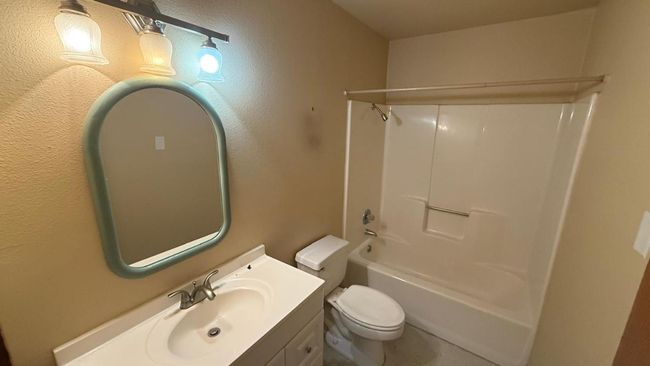 Bathroom with toilet, shower / tub combination, and vanity | Image 15