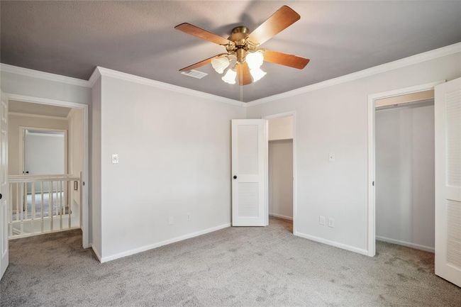 This is the third secondary bedroom with an extra spacious closet. Every bedroom features crown moldings, ceiling fans and great space. | Image 31