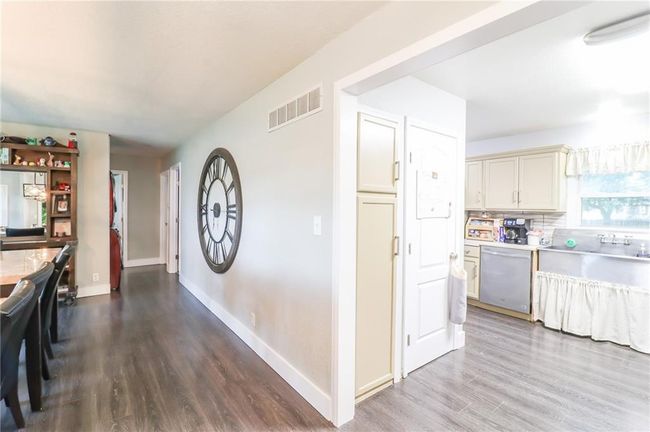Kitchen featuring dishwasher, wood finished floors, light countertops, and decorative backsplash | Image 23